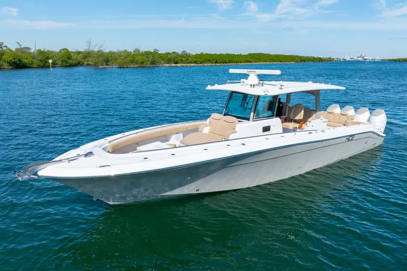Slide: The Image of 2027 HCB 42 Lujo luxury boat on clear blue water, showcasing sleek design and spacious seating. - 16