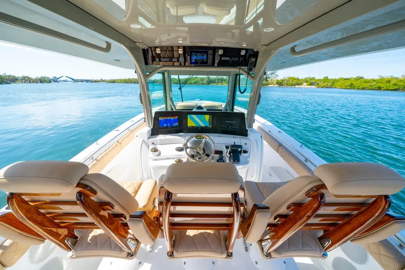 Slide: The Image of 2027 HCB 42 Lujo boat cockpit with luxurious seating and advanced navigation systems. - 19