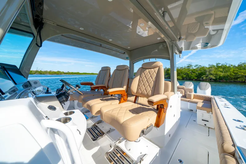 Slide: The Image of Luxurious 2027 HCB 42 Lujo boat interior with plush seating and scenic water view. - 22