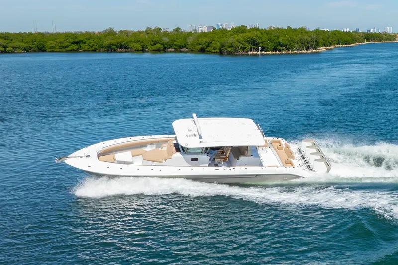 Slide: The Image of 2027 HCB 42 Lujo luxury boat cruising on a scenic blue waterway. - 25