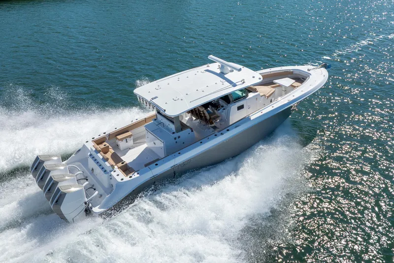 Slide: The Image of 2027 HCB 42 Lujo boat cruising on open water, showcasing sleek design and powerful engines. - 27