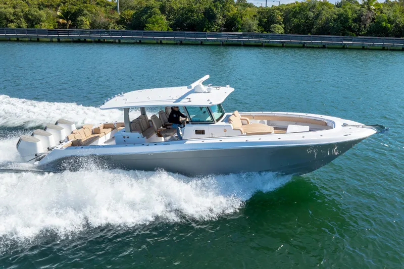 Slide: The Image of 2027 HCB 42 Lujo luxury boat cruising on a scenic waterway. - 28