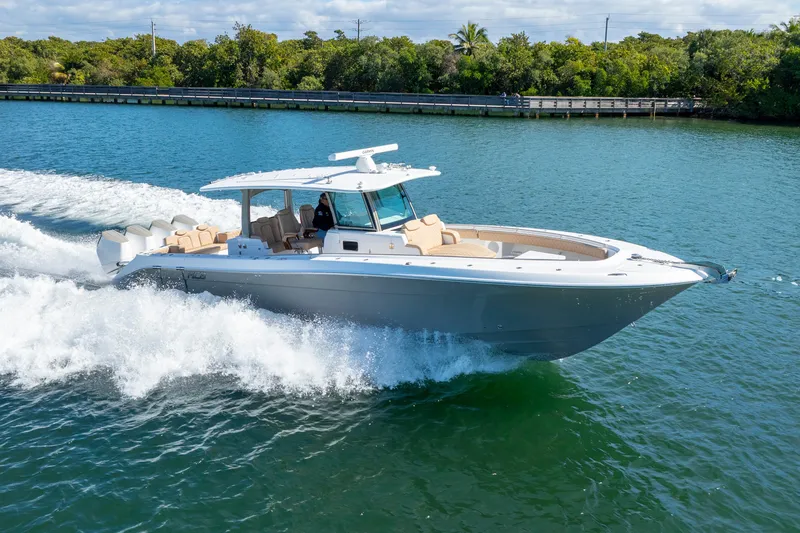 Slide: The Image of 2027 HCB 42 Lujo luxury boat cruising on a scenic waterway. - 29