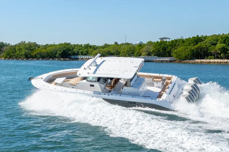 Slide: The Image of 2027 HCB 42 Lujo boat cruising on water, showcasing sleek design and powerful engines. - 31
