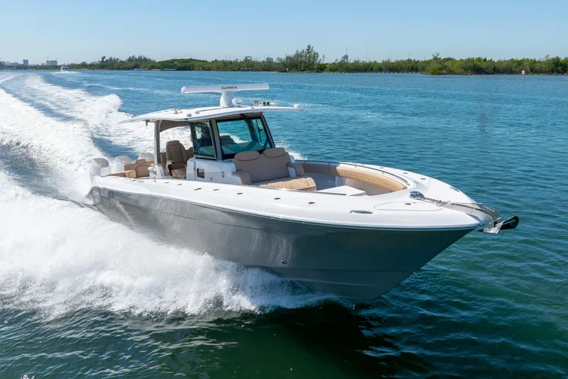 Slide: The Image of 2027 HCB 42 Lujo boat cruising on clear blue water, showcasing sleek design and luxury features. - 32