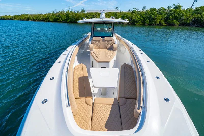 Slide: The Image of 2027 HCB 42 Lujo boat with luxurious seating on calm water. - 33