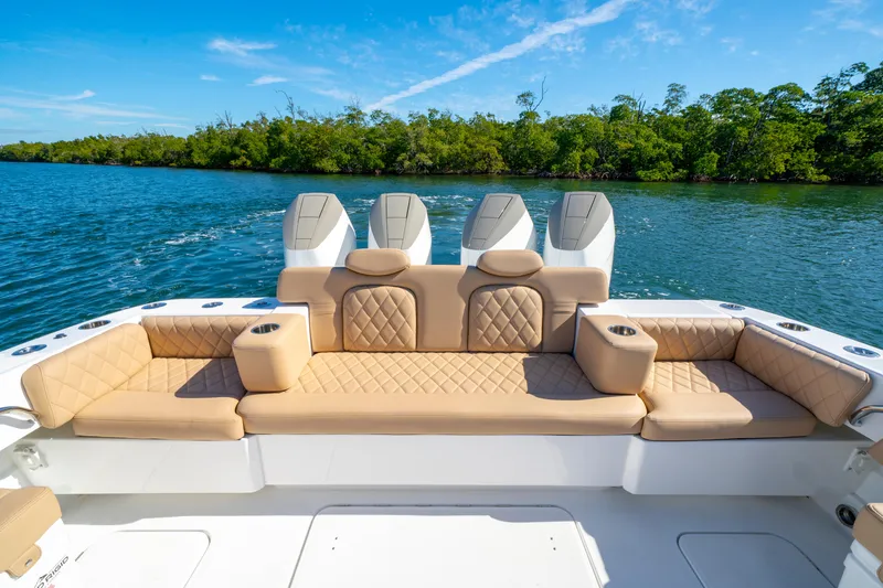 Slide: The Image of Luxurious seating on 2027 HCB 42 Lujo boat with scenic water backdrop. - 41