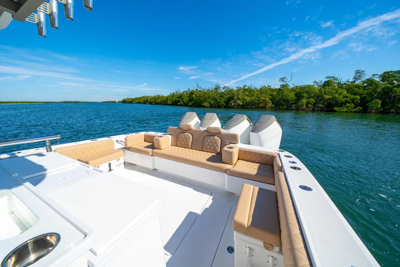 Slide: The Image of Luxurious 2027 HCB 42 Lujo yacht with elegant seating, cruising on serene waters. - 42