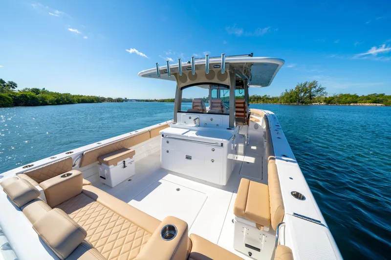 Slide: The Image of Luxurious 2027 HCB 42 Lujo boat on serene blue waters under clear skies. - 43