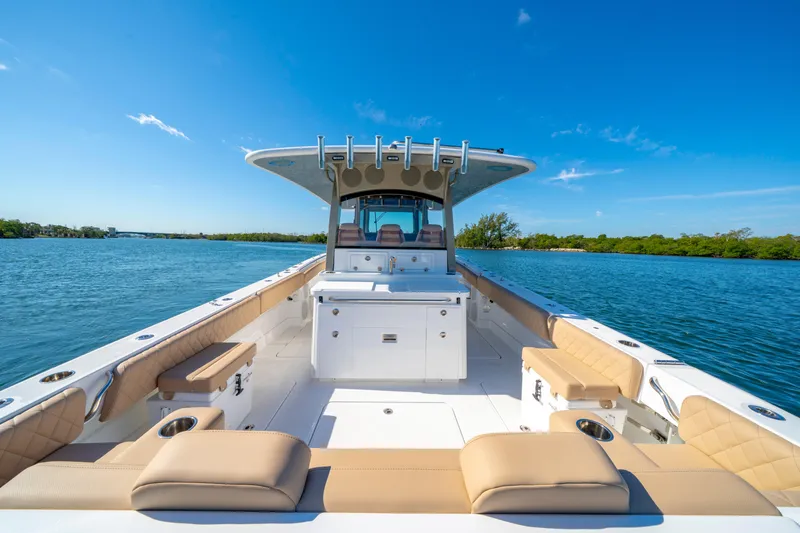 Slide: The Image of Luxurious 2027 HCB 42 Lujo boat on serene water, featuring spacious deck and comfortable seating. - 44
