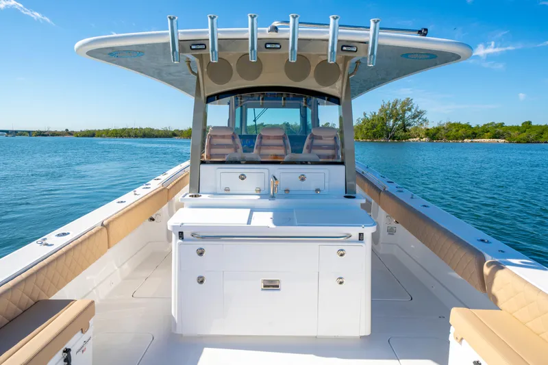 Slide: The Image of Luxury HCB 42 Lujo boat, 2027 model, cruising on serene blue waters under clear skies. - 45