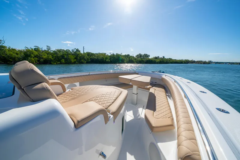 Slide: The Image of Luxurious 2027 HCB 42 Lujo boat with elegant seating on a sunny day. - 5