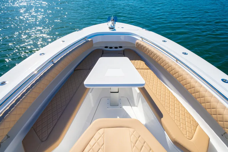 Slide: The Image of Luxurious seating area on the 2027 HCB 42 Lujo boat, with elegant tan upholstery. - 7