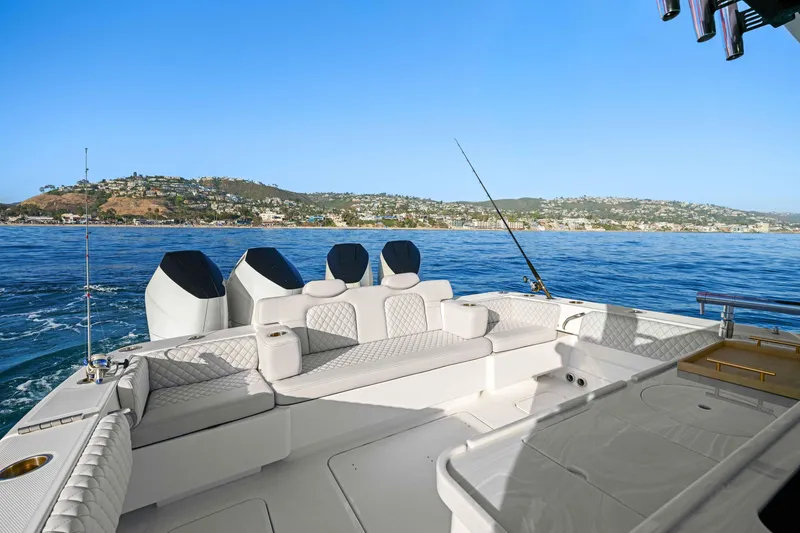 Slide: The Image of Luxurious 2026 HCB 42 Lujo boat with plush seating, cruising on serene blue waters. - 17