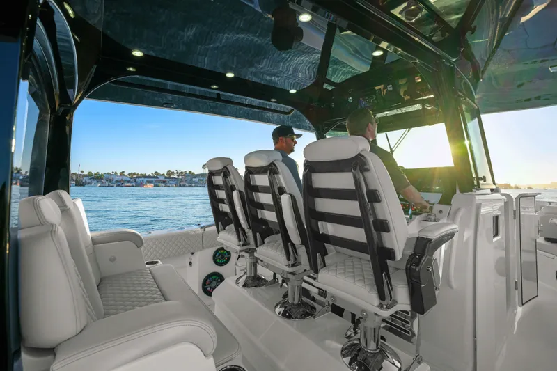 Slide: The Image of Interior view of 2026 HCB 42 Lujo boat with luxurious seating and ocean backdrop. - 34