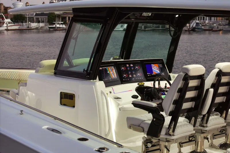 Slide: The Image of Helm of 2026 HCB 42 Lujo boat with advanced navigation displays and luxurious seating. - 15