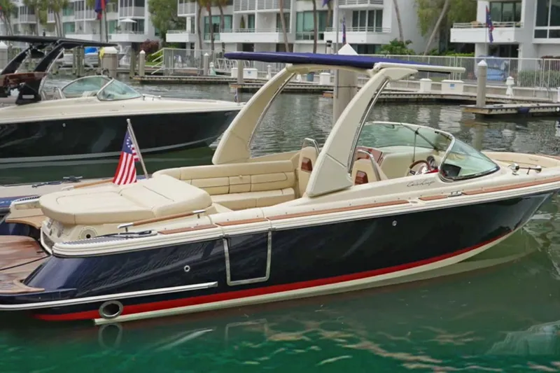 The Image of 2022 Chris-Craft Launch 25 GT boat docked in marina, featuring elegant design and American flag. - 1