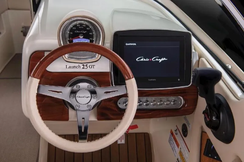 Slide: The Image of 2022 Chris-Craft Launch 25 GT dashboard with steering wheel and Garmin display. - 6