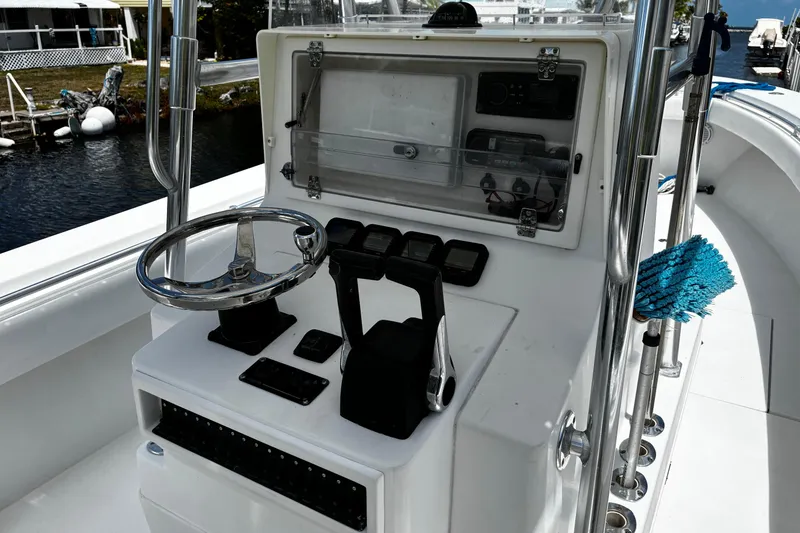 Slide: The Image of Center console of a 2007 Contender 33 Tournament boat with steering wheel and controls. - 10
