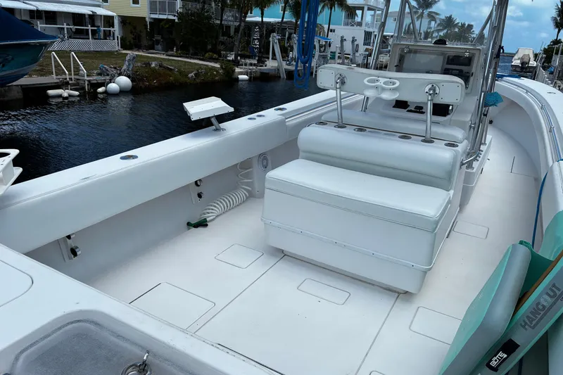 Slide: The Image of 2007 Contender 33 Tournament boat interior with seating and console, docked by waterfront homes. - 13