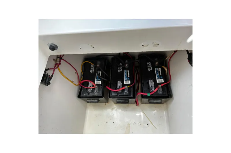 Slide: The Image of Three marine batteries in a 2007 Contender 33 Tournament boat compartment. - 14