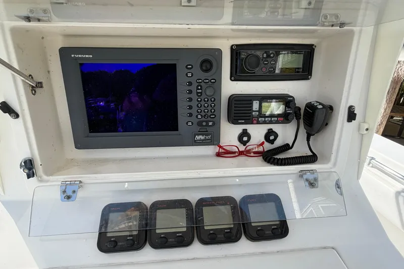 Slide: The Image of Control panel of a 2007 Contender 33 Tournament boat with navigation and communication equipment. - 17