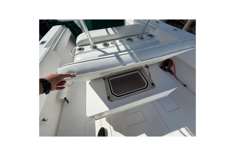Slide: The Image of 2007 Contender 33 Tournament boat with open storage compartment and seating area. - 20