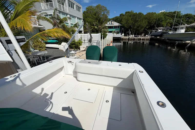 Slide: The Image of 2007 Contender 33 Tournament boat docked near waterfront homes and lush greenery. - 21