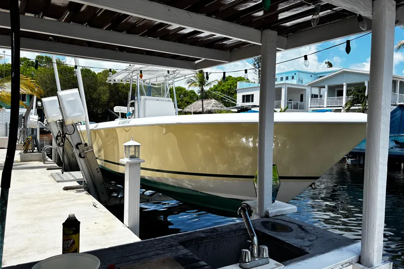 Slide: The Image of 2007 Contender 33 Tournament boat docked at a marina with waterfront homes in the background. - 4