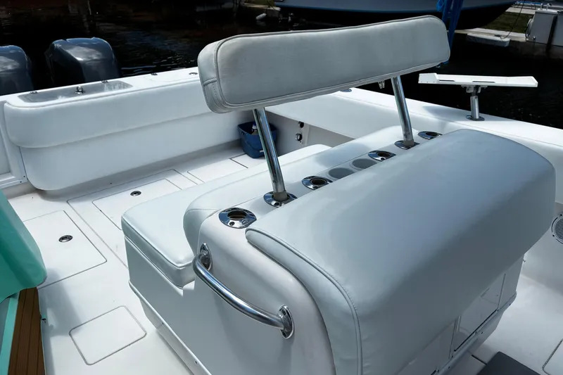 Slide: The Image of 2007 Contender 33 Tournament boat interior with cushioned seating and rod holders. - 9