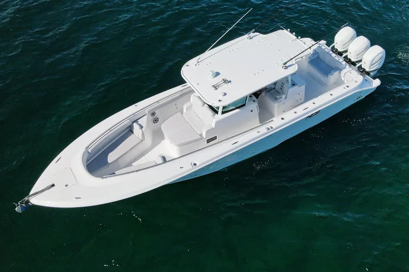 Slide: The Image of 2027 HCB 39 Speciale boat on open water, featuring sleek design and triple engines. - 13