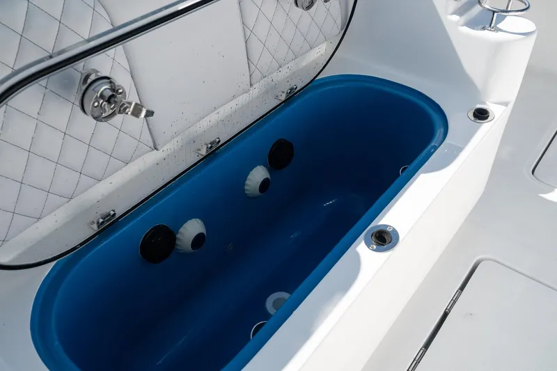Slide: The Image of Livewell compartment on 2027 HCB 39 Speciale boat, featuring blue interior and white exterior. - 18