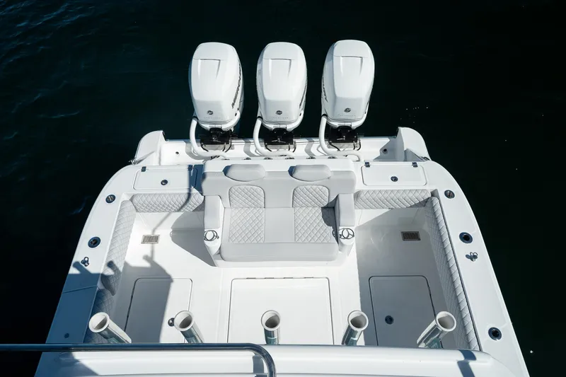 Slide: The Image of 2027 HCB 39 Speciale boat with triple outboard engines and luxurious seating. - 34