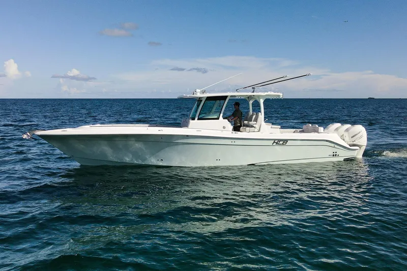 Slide: The Image of 2027 HCB 39 Speciale boat cruising on open water under a clear sky. - 4