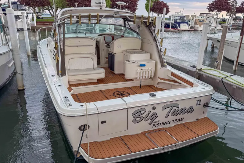 The Image of 1997 Sea Ray 330 Express Cruiser docked, featuring "Big Tuna" fishing team branding. - 1