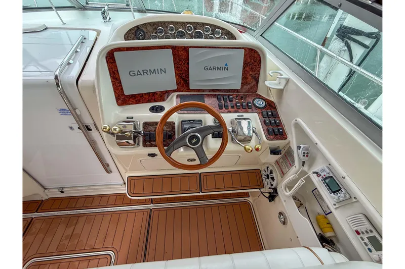 Slide: The Image of 1997 Sea Ray 330 Express Cruiser helm with Garmin navigation displays and wood accents. - 12