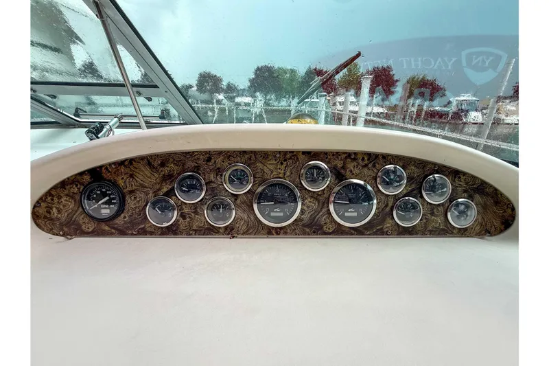 Slide: The Image of Dashboard of a 1997 Sea Ray 330 Express Cruiser with multiple gauges and controls. - 14