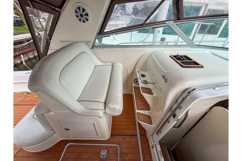 Slide: The Image of 1997 Sea Ray 330 Express Cruiser interior with white seating and wooden flooring. - 15