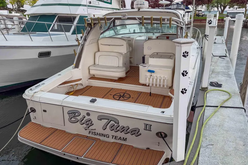 Slide: The Image of 1997 Sea Ray 330 Express Cruiser docked, featuring "Big Tuna" fishing team branding. - 2