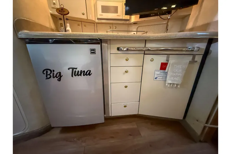 Slide: The Image of 1997 Sea Ray 330 Express Cruiser kitchen with "Big Tuna" fridge and cabinetry. - 20