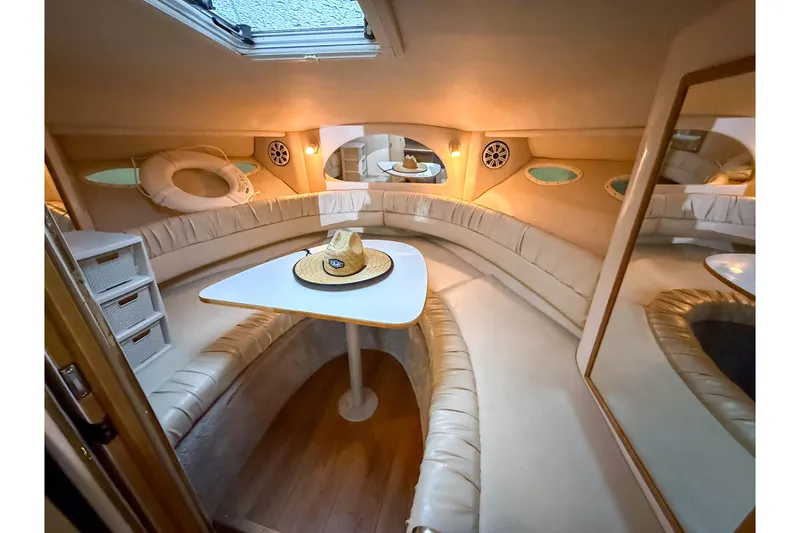 Slide: The Image of Interior of 1997 Sea Ray 330 Express Cruiser with cozy seating and table. - 22