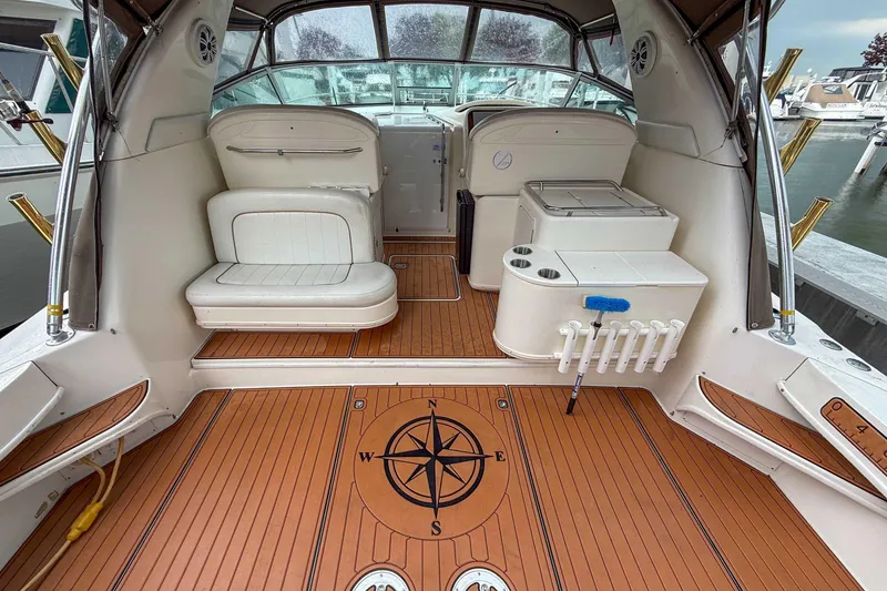 Slide: The Image of 1997 Sea Ray 330 Express Cruiser interior with compass design on teak flooring. - 8