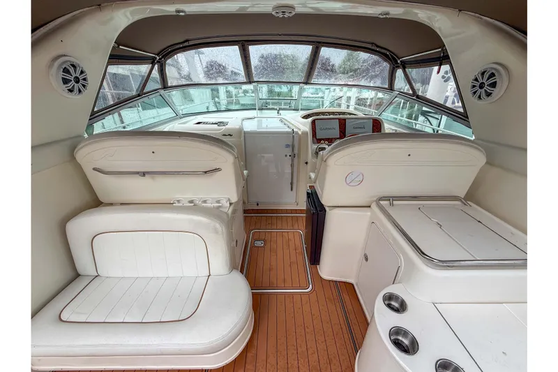 Slide: The Image of 1997 Sea Ray 330 Express Cruiser interior with white seating and wood flooring. - 9