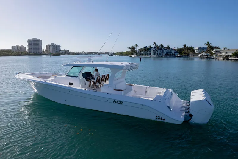 Slide: The Image of HCB 48 Campeon 2027 boat cruising on calm waters near coastal buildings. - 10