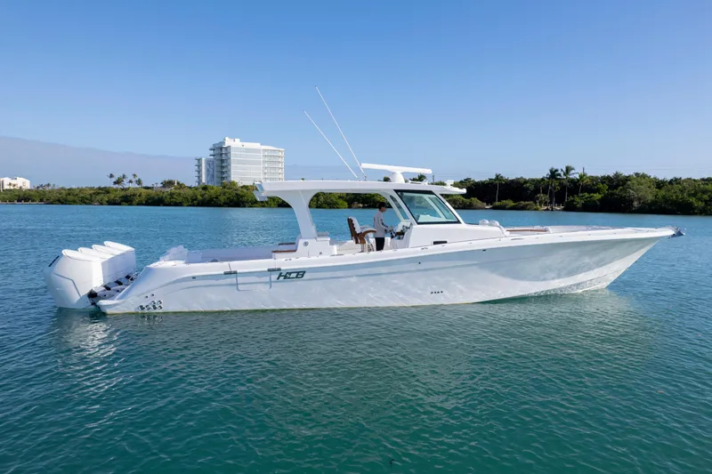 Slide: The Image of 2027 HCB 48 Campeon boat on calm water, clear sky background. - 11