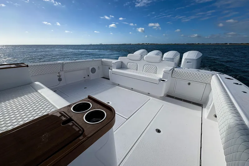 Slide: The Image of Luxurious 2027 HCB 48 Campeon boat deck with plush seating and ocean view. - 14