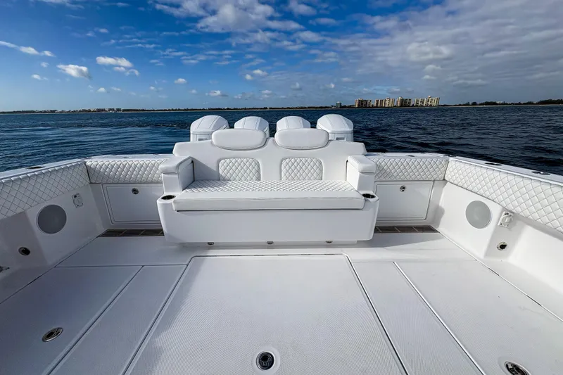 Slide: The Image of Luxurious 2027 HCB 48 Campeon boat interior with white seating and ocean view. - 15