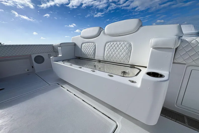 Slide: The Image of Luxurious seating on 2027 HCB 48 Campeon boat under a clear blue sky. - 17