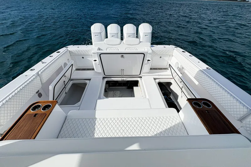 Slide: The Image of Luxurious 2027 HCB 48 Campeon boat interior with quilted seating and cup holders on open water. - 20
