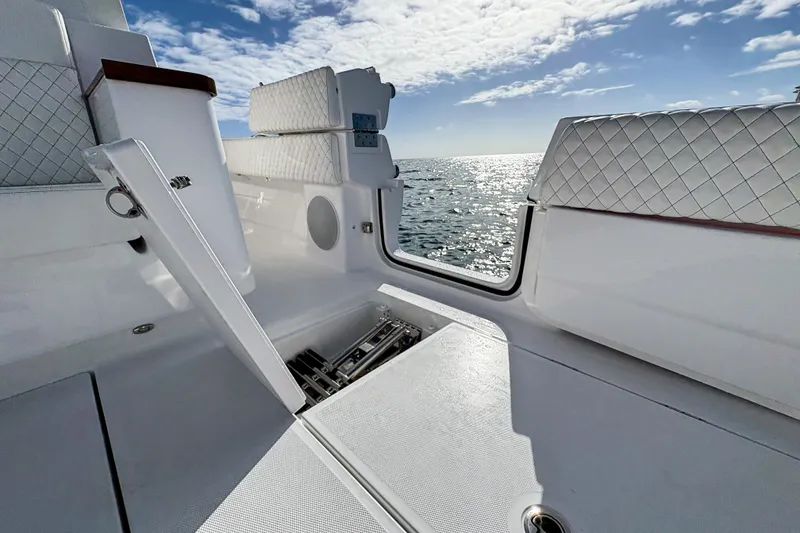 Slide: The Image of 2027 HCB 48 Campeon boat interior with open hatch, ocean view, and quilted seating. - 21